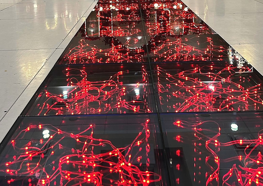 A mirrored runway lit with red fibre optic light