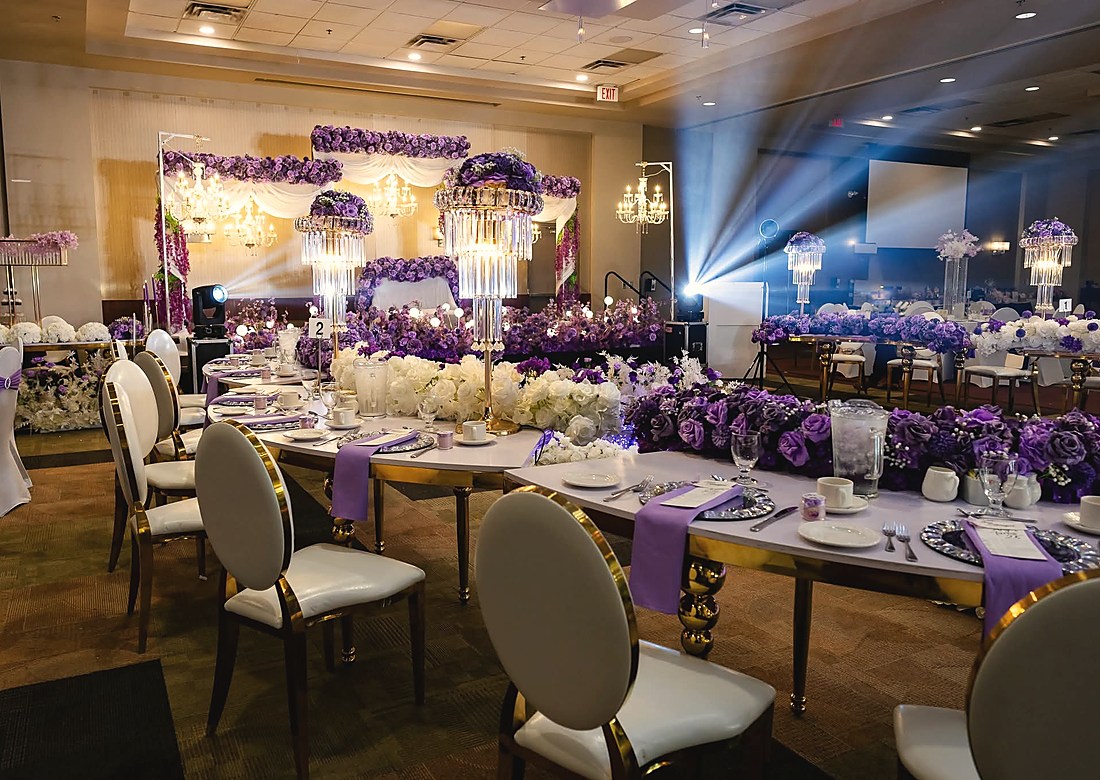 Banquet tables in cream and purple with tall floral centrepieces