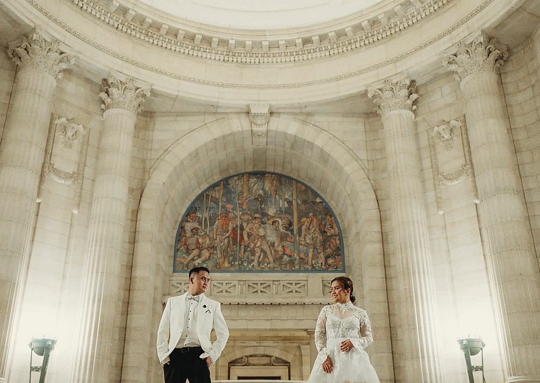 A couple on the marble staircase of the Legislative Building