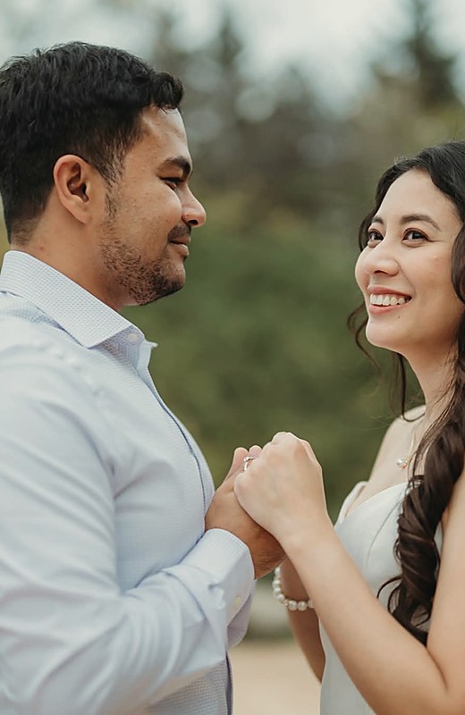 A couple dancing outdoors with their hands joined