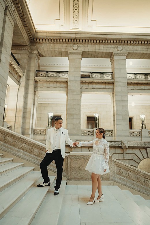 A couple on the marble staircase of the Legislative Building